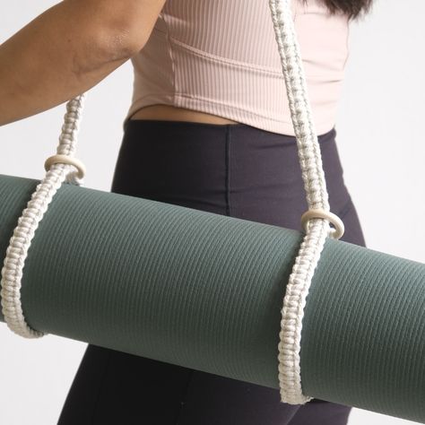 From yoga mats to picnic blankets, or even your camera stand – our hand-knotted macrame strap is the stylish, all-purpose carrier you didn’t know you needed! Make it uniquely yours or a thoughtful gift – personalize with a leather name deboss tag. #fegome #matcarrier #macrameyogastrap #macramé #customisegifts #yogakl Macrame Yoga Strap Diy, Macrame Yoga Mat Strap Tutorial, Leather Yoga Mat Strap, Macrame Strap, Macrame Products, Yoga Mat With Strap, Yoga Mat Carrier, Camera Stand, Christmas Bazaar