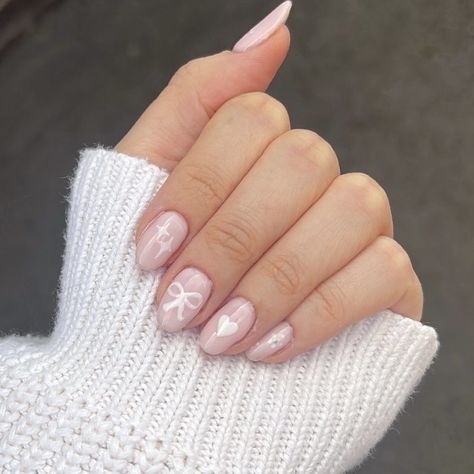 Pink nails with white nail art. The nails have stars, bows, hearts and flowers on them. Nails Bows Design, Short And Simple Nail Designs, Pink Nail Simple, Bow Pink Nails, Cute Nails Coquette, Coquette Nail Inspo Short, Coquette Nails Short Simple, Heart And Bow Nails, Croquette Nails Pink