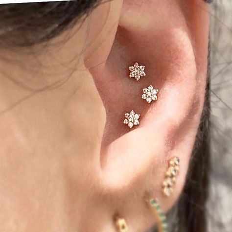 Our flower studs — each with six diamond petals and a round diamond center — bloom brilliantly in the Conch. Triple Conch, Triple Conch Piercing, Conch Piercing Stud, Conch Stud, Conch Piercings, Maria Tash, Diamond Baguette, Conch Piercing, Diamond Flower