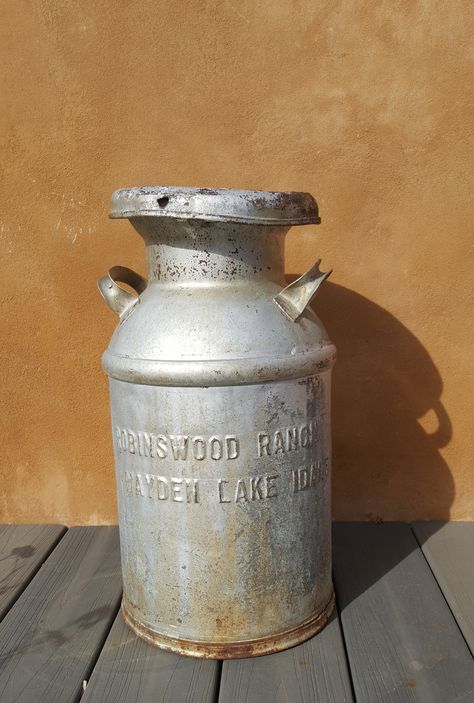 Vintage Metal Gallon Milk Jug | Antique Milk Can | Vintage Dairy Tin FOR SALE Vintage milk can from Robinswood Ranch Hayden Lake Idaho. Great for farmhouse decor. The lid comes off. Great for your front porch, garden or vintage interiors. Antique Milk Jug Ideas, Antique Milk Jug, Antique Milk Can, Vintage Milk Jug, Front Porch Garden, Vintage Milk Can, Porch Garden, Milk Cans, Vintage Interiors