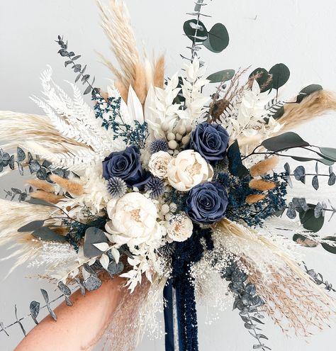 Dried everlasting bouquet including pampas grass, preserved roses, hydrangea, silver Brunia, bunny tail grass, sola wood flowers. Perfect bridal bouquet, bridesmaids bouquet, or place in vase for home decor. Hand tied with silk chiffon ribbon.  -Large Bouquet is approximately 16" (shown) -Medium Bouquet is approx 14" -Small Bouquet is approx 8"  *Each arrangement is handmade to order and we try our best to ship out within the listed processing time. If you need your item sooner, please message m Rustic Bridal Bouquet Dried Flowers, Magnolia And Pampas Bouquet, Blue And Wedding Color Schemes, Dark Blue Champagne Wedding, Cascading Winter Bouquet, Navy Blue Wedding Theme Rustic, Cat Tail Floral Arrangements, Rose Gold And Navy Blue Wedding Theme Flowers, Sage Green And Navy Blue Wedding Bouquets