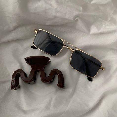 Gold vintage inspired sunglasses laying on white bedding with a chocolate brown hair claw Vintage Aesthetic Accessories, Aesthetic Sunglasses Vintage, Vintage Sunglasses Aesthetic, Hair Claw Aesthetic, Claw Aesthetic, Cool Sunglasses Aesthetic, Sunglass Aesthetic, Shades Aesthetic, Indie Sunglasses