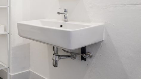 The Stylish Way To Utilize Under-The-Sink Storage Space In Your Bathroom - House Digest Hiding Pipes Under Bathroom Sink, Tiniest Bathroom, Under The Sink Storage, Bathroom Sink Diy, Under Bathroom Sink, Sink Skirt, Floating Sink, Hiding Ugly, Sink Cover