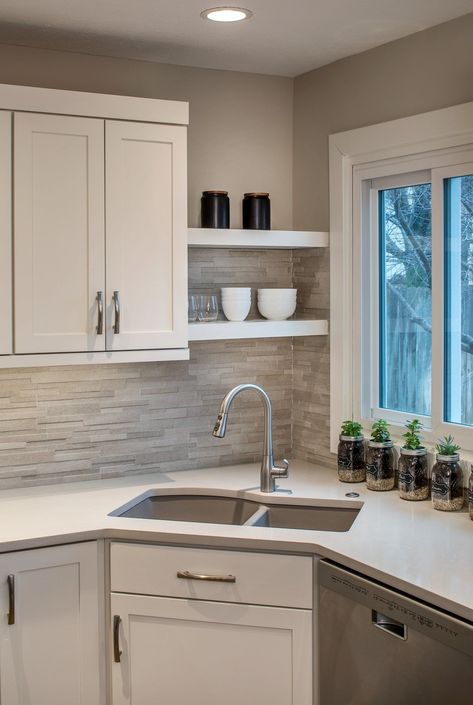 Did we say that we love open shelving?  We really do.  It is so fun to let the basics of your day become art.  Simply.  Beautiful.  #hcremodel #omahanebraska #openshelving L Shape Floating Shelves Kitchen, Habersham Kitchen, Kitchen With Corner Sink, Corner Shelves Kitchen, Kitchen Cabinets Open, Small L Shaped Kitchens, Corner Kitchen Sink, Upper Kitchen Cabinets, White Kitchen Backsplash