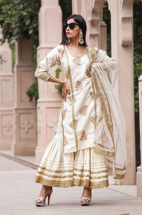 Beautiful Chanderi Kurti. Paired with Sharara and net dupatta. Embellished with gota patti and golden lace and prints. #dress #sharara #chanderisilk #festival #traditional #gulabojaipur #dress #silhouettes #indowestern Lace Design On Suits, Lace Designs On Suits, Dress Sharara, Ethnic Trends, Wedding Fits, Golden Lace, Summer 19, Sharara Suit, Net Dupatta