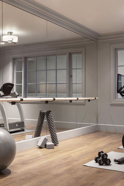 modern gray home gym Full Wall Mirror Gym, Home Gym Stair Master, Exercise Room Mirrors, House Gym Room Small Spaces, Home Gym Wall Mirrors, Basement Exercise Room Ideas, Exercise Room Design, Chic Home Gym, Basement Must Haves