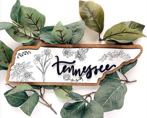 Tennessee wood wall art is a beautiful and unique way to show your love for the Volunteer State. This hand-crafted piece features a map of Tennessee with the state flowers, making it the perfect gift for any Tennessean or fan of the state.

#Tennessee #WoodWallArt #MapOfTennessee #StateFlowers Map Of Tennessee, Alaska Cabin, Tennessee House, State Flowers, Tennessee Map, Halloween Costumes To Make, Laser Projects, Laser Ideas, Best Housewarming Gifts