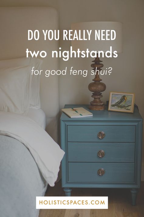 Photo of blue nightstand with lamp, picture, and journal next to bed. Text: do you really need two nightstands for good feng shui? holisticspaces.com Feng Shui Bedroom Nightstand, Bedroom One Nightstand Ideas, Matching Nightstands Bedroom, One Bedside Table In Bedroom, Only One Nightstand In Bedroom, Bedroom Layout With One Nightstand, Single Nightstand Bedroom Layout, Feng Shui Nightstand, Bedrooms With One Nightstand