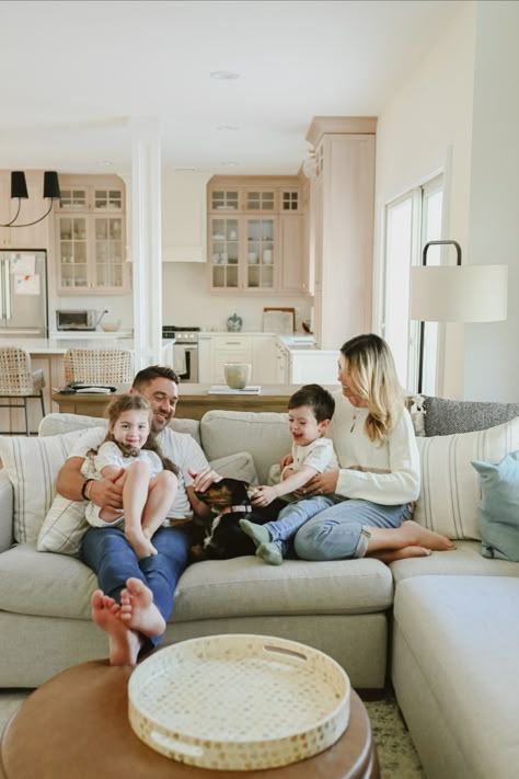 Family playing on the sofa in the living room, father, mother, daughter, son and a black dog In Home Lifestyle Session Family Outfits, Inside Home Photoshoot Ideas, Family Home Shoot, I’m Home Family Photos, Family Pictures In Home, Living Room Family Photoshoot, In Home Lifestyle Session Family, In Home Family Photo Shoot, At Home Family Photoshoot