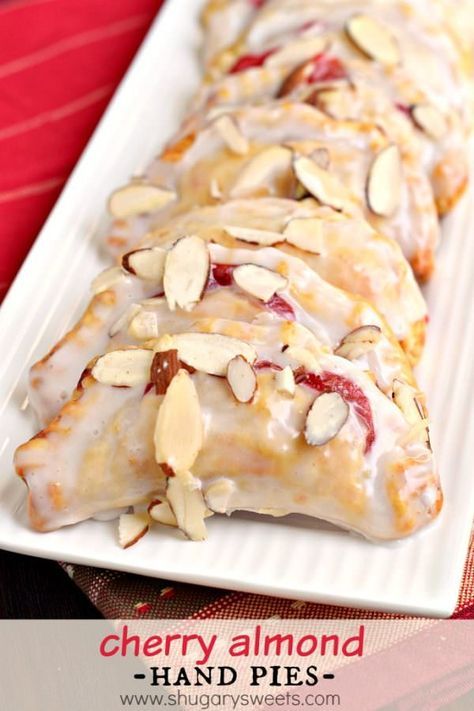 Easy, baked Cherry Almond Hand Pies! A flaky crust with a cherry almond pie filling, dipped in a sugary glaze and topped with sliced almonds. The perfect dessert! Cherry Almond Pie, Fruit Hand Pies, Almond Pie, Cherry Hand Pies, Hand Pie Recipes, Funnel Cakes, Shugary Sweets, Cherry Desserts, Pop Tart