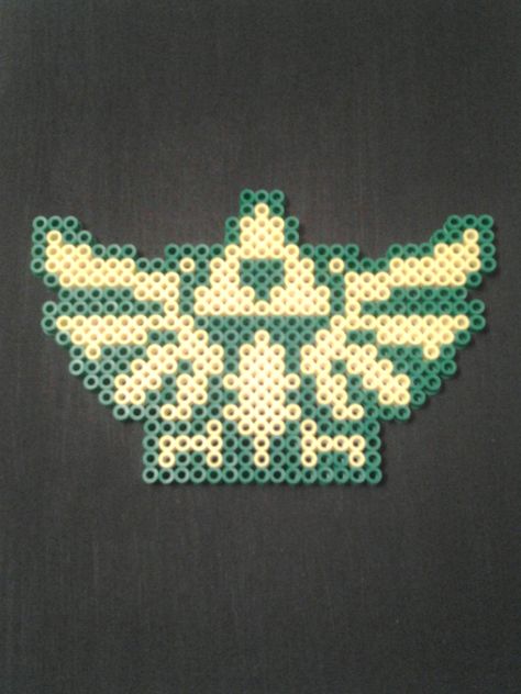 Legend of Zelda Hylian Crest Perler Bead Art By Sam.S Zelda Tears Of The Kingdom Perler Beads, Loz Perler Beads, Zelda Beads Pattern, Legend Of Zelda Perler Bead Patterns, Perler Mobile, Zelda Perler Bead Patterns, Legend Of Zelda Perler Beads, Link Perler Beads, Legend Of Zelda Pixel Art