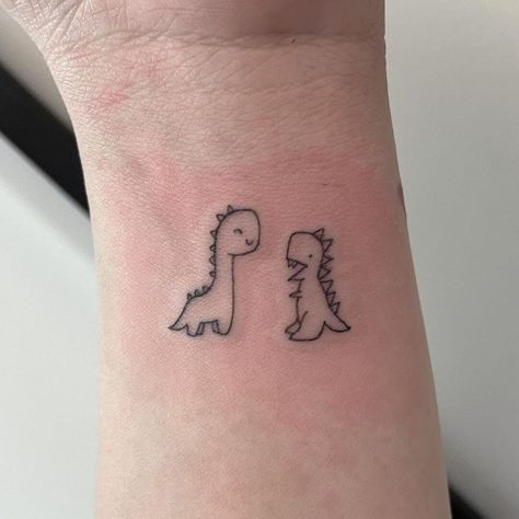 Small Cartoon Dinosaur Tattoo, Dinosaur Friend Tattoo, Line Work Dinosaur Tattoo, Trex Cute Tattoo, Dinosaur Small Tattoo, Cute Dinosaur Tattoo Ideas, Cute Trex Tattoo Ideas, Mom And Son Dinosaur Tattoo, Cute Dino Tattoo Ideas