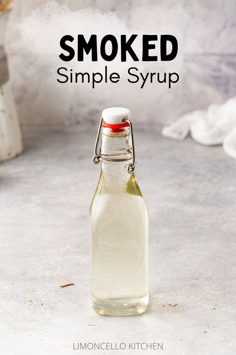 Smoked simple syrup in a swing-top bottle on a gray countertop. Text above the bottle reads "Smoked Simple Syrup" with a light smoke pattern behind it. Smoked Simple Syrup, Recipes Coffee Drinks, Drinks Lemonade, Bourbon Old Fashioned, Simple Syrup Cocktails, Simple Syrups, Smoked Cocktails, Drink Syrups, Homemade Soda