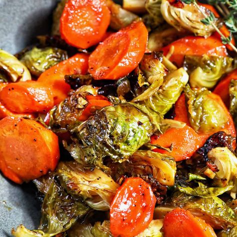 This roasted brussels sprouts and carrots recipe is simple and easy to make. It's a delicious vegetable side dish for dinners and holidays. Recipe at UrbanBlissLife.com. Stove Top Veggie Recipes, Brussels Sprouts And Carrots Recipe, Carrots And Brussel Sprouts Recipe, Maple Glazed Carrots And Brussel Sprouts, Brussel Sprout Thanksgiving Recipes, Brussel Sprout And Carrot Recipes, Roasted Brussels Sprouts And Carrots, Brussel Sprout Recipes Thanksgiving, Basalmic Brussel Sprouts