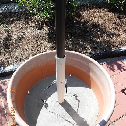 umbrella holder in a cement plant container, concrete masonry, diy, repurposing upcycling, pins to hold the umbrella from flying off Outdoor Umbrella Stand, Cement Flower Pots, Patio Umbrella Stand, Diy Planter Box, Diy Flower Pots, Flower Pots Outdoor, Patio Shade, Cement Pots, Beautiful Yards