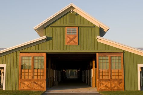 Large pea green barn with cream colored trim and lightly stained wood doors and shutters, green grass, light blue sky Agricultural Architecture, Exterior Barn Door Hardware, Custom Horse Stalls, Exterior Barn Doors, Green Barn, Barn Shop, Fishing Cabin, Barn House Design, Barn Pictures