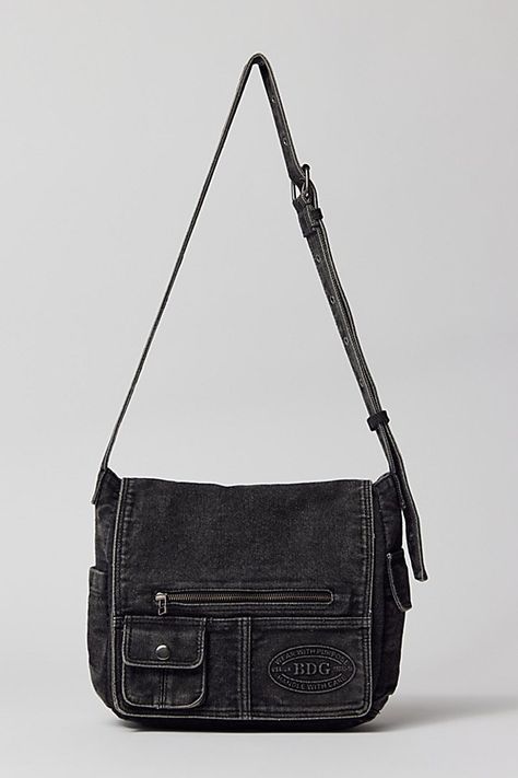 Essential messenger bag crafted from premium BDG denim. Low-profile silhouette with a pocketed flap closure. Lined interior with two pockets and plenty of space for your essentials. Complete with a zip pocket at the back for easy access, plus a water bottle pocket at the side. Finished with an adjustable strap - wear it on your shoulder or crossbody. Urban Outfitters exclusive. Features BDG denim messenger bag Washed soft denim with tons of storage Plenty of pockets inside and out Water bottle p Cross Body Bag For School, Cute Black Leather Bag, Messenger Bag Outfit, Messenger Bag Aesthetic, Denim Messenger Bag, Black Messenger Bag, Messanger Bag, Urban Outfitters Bag, Over The Shoulder Bag