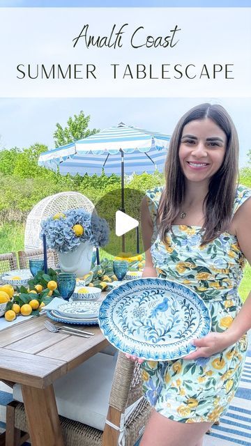 Laura | Tablescapes | Interior Styling on Instagram: "#ad I had so much fun bringing coastal Italy to my backyard with @fitzandfloydofficial’s gorgeous Sicily Blue collection! 💙🩵💛🤍 ⠀⠀⠀⠀⠀⠀⠀⠀⠀ How pretty are the floral designs on these plates?! I especially love the blue birds on the salad plates and serving platter 🤩😍 ⠀⠀⠀⠀⠀⠀⠀⠀⠀ One of my favorite ways to dress up blue and white for summer is to throw in a vibrant splash of color with citrus. Lemons add such a fun seasonal touch and play into the Amalfi theme so perfectly don’t they? 🍋🍋🍋 ⠀⠀⠀⠀⠀⠀⠀⠀⠀ I created a garland by using my new favorite centerpiece technique: overlapping faux flower stems, and in this case, lemon branch stems. At the center is a bouquet of light blue hydrangeas in a white Anduze planter with some fresh lemons m Amalfi Theme, Amalfi Coast Style, Coastal Italy, Lemon Branch, High Top Table, High Top Tables, Blue Hydrangeas, Coast Style, Flower Stems