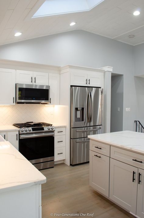 white kitchen cabinets, vaulted shiplap ceiling with skylight, gray island, white gray marble countertop Small Kitchen Skylight Ideas, Vaulted Kitchen Cabinets, Split Level House Kitchen, Vaulted Shiplap Ceiling, Kitchen With Vaulted Ceiling, Kitchen Skylight, Split Level Kitchen, Split Level Kitchen Remodel, Ranch Kitchen Remodel