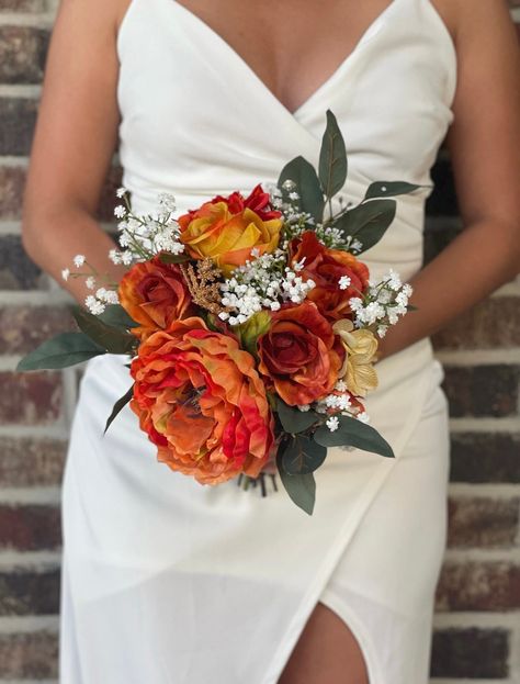 "This exquisite bouquet is made with burnt orange/terracotta roses, orange dahlias and hydrangeas, orange peonies, eucalyptus and baby's breath to give a sweet, elegant look to your wedding. The handle of the bouquet is wrapped with ivory satin ribbon. If you would like the wrap of the bride bouquet different from your bridesmaids or vise versa, please feel free to look around my shop for ideas and let me know how I can customize it for you. Want to add burlap, other colors, brooches? I will gl Rustic Orange Bouquet, Simple Fall Wedding Bouquets, Orange Bride Bouquet, Orange And Green Bouquet, Rusty Orange Wedding, Orange Bouquet Wedding, Burnt Orange Wedding Bouquet, Terracotta Roses, Red And Orange Wedding