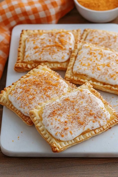 Indulge in a delightful treat with these homemade pumpkin pie pop tarts. Perfect for breakfast or a sweet snack, these flaky pastries filled with spiced pumpkin filling are sure to impress. Enjoy the cozy flavors of fall in every bite. Whether you bake them for a weekend brunch or make a batch for your holiday gathering, these pumpkin pie pop tarts will be a hit with everyone. Pumpkin Spice Pop Tarts, Homemade Pumpkin Poptarts, Pumpkin Poptarts Homemade, Pumpkin Pie Pop Tarts, Pie Crust Pop Tarts, Healthy Pop Tart Recipe, Pop Tarts With Pie Crust, Pumpkin Pop Tarts, Yummy Breakfast Ideas