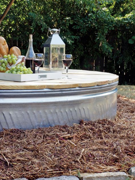 Turn a stock tank and few old tires into this industrial-style fire pit. Stock Tank Fire Pit Ideas, Stock Tank Fire Pit, Trough Fire Pit, Fire Pit Ideas Outdoor, Fire Pit Screen, Cozy Fire Pit, Tank Pools, Feeding Trough, Fire Pit Seating Area