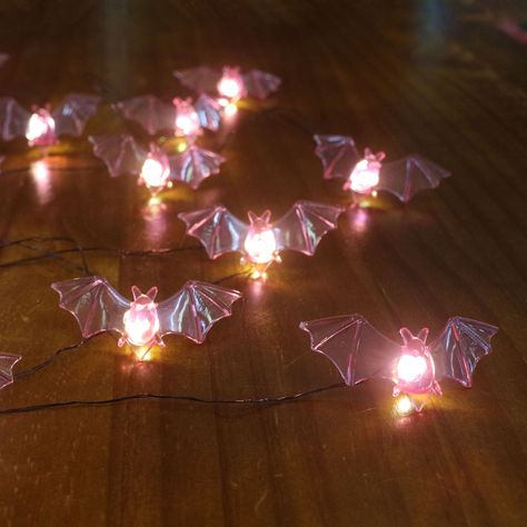 Find these 12ct. Purple Bat Icon LED String Lights by Ashland® at Michaels. This battery-operated string of bat lights is the perfect way to add an eerie glow to Halloween wreaths, garlands and other décor accents. Bring spooky fun to your indoor space with these bat string lights. This battery-operated string of bat lights is the perfect way to add an eerie glow to Halloween wreaths, garlands and other décor accents. Details: Purple bats with black wire 6 ft. (1.8 m) lighted length 7 ft. (2.1 m Cute Colorful Halloween Decor, Bat Icon, Purple String Lights, Bat Light, Halloween String Lights, Chic Bedrooms, Bat Decorations, Autumnal Equinox, Halloween House Party