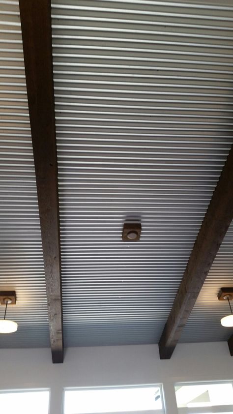 Corrugated tin ceiling with beams Metal Roof Interior Tin Ceilings, Galvanized Ceiling Ideas, Galvanized Tin Ceiling, Metal Ceiling Ideas, Corrugated Ceiling, Corrugated Metal Ceiling, Corrugated Tin Ceiling, Metal Panel Ceiling, Corrugated Wall