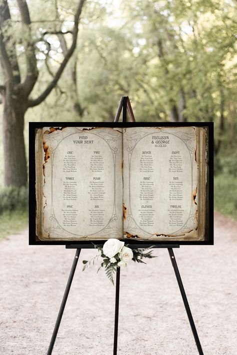 "This unique seating chart is made to look like a vintage open book and is perfect for a fantasy wedding or event. Featuring the look of distressed burned pages and a vintage art nouveau design bordering the pages. We add your guest list to the book image with a whimsical font. Questions? ⇣ No need to wait for our response if you send a message, keep scrolling down and read through the entire listing as we try to answer every question regarding material choice, display information, and shipping/ Medieval Wedding Seating Chart, Enchanted Forest Seating Chart, Fantasy Book Wedding, Vintage Seating Chart Wedding, Seating Chart Wedding Unique, Fantasy Theme Wedding, Midevil Wedding Ideas, Book Seating Chart Wedding, Medieval Wedding Decorations