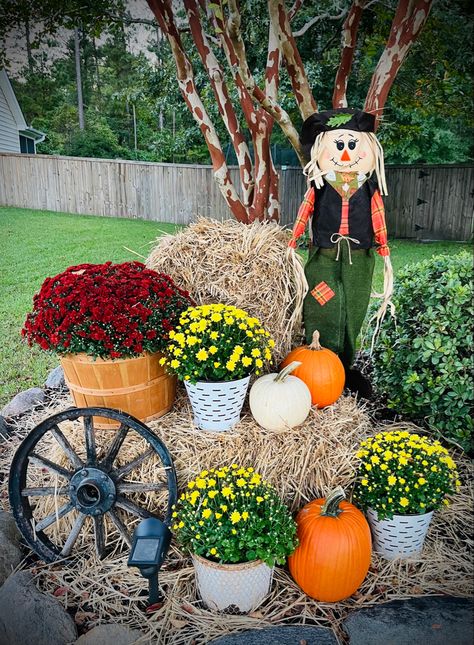 Scarecrow, straw-bale, pumpkins, mums, wagon wheel, country, farmhouse Straw Bales Decorations Fall, Fall Decor With Straw Bales, Fall Decorations With Hay Bales, Fall Hay Bale Decor Porch Ideas, Straw Bale Decor Fall, Fall Hay Bale Decor, Hay Bale Decor, Fall Festival Decorations, Mums In Pumpkins