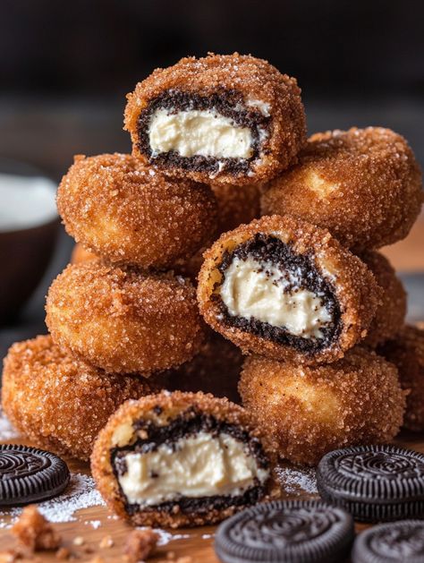 Cookies & Cream Cheesecake-Filled Deep-Fried Oreos 🍪  🍪 𝗖𝗵𝗲𝗲𝘀𝗲𝗰𝗮𝗸𝗲 𝗙𝗶𝗹𝗹𝗶𝗻𝗴 🍪 8 oz cream cheese, softened  1/2 cup granulated sugar  1/2 cup sour cream  1 tsp vanilla extract  1/2 cup crushed Oreo cookies  🍪 𝗢𝗿𝗲𝗼𝘀: 1 package of regular Oreos (or your favorite variety)  🥣 𝗕𝗮𝘁𝘁𝗲𝗿: 1 cup all-purpose flour  1/2 cup granulated sugar  1 tsp baking powder  1/4 tsp salt  1 large egg  1 cup milk  1 tsp vanilla extract   𝗙𝗿𝘆𝗶𝗻𝗴: Vegetable oil (for frying) Oreos Cheesecake, Fried Oreo, Deep Fried Oreos, Crushed Oreo, Baking Aesthetic, Cookies And Cream Cheesecake, Fried Oreos, Cream Cheesecake, Creative Baking