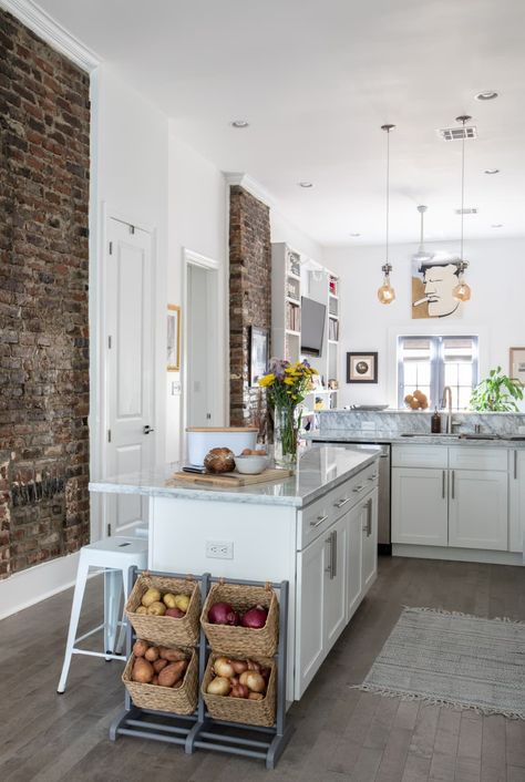 "I love New Orleans’ signature high ceilings. I’m a tall guy at 6’4”, so 12’ ceilings were a must. I also love that the original brick fireplaces simultaneously help to define the separate spaces and maintain the home's historical charm. Sadly, they don’t work, but they look great," says Luke. Credit: <a href="jacquelinemarque.com">Jacqueline Marque</a> New Orleans Shotgun House, Not Minimalist, Shotgun House Interior, New Orleans Decor, Brick Fireplaces, Narrow Lot House, Large Open Kitchens, Shotgun House, Louisiana Homes