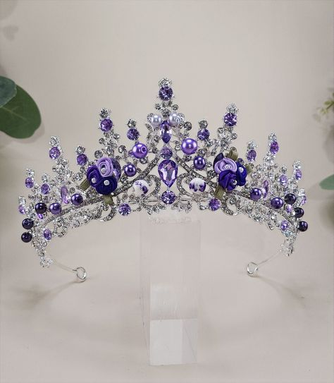 Introducing Priscilla our custom Purple Quinceanera Tiara - perfect for your special event! Whether it's your big day as a bride, a Quinceanera, or a pageant, this Purple tiara will be the crowning glory of your outfit. Crafted with exquisite attention to detail and vibrant purple stones, flowers, lavender and purple crystals, beads. Our unique custom design features an intricately detailed setting with finely cut stones that sparkle and glisten in the light with flower and bead elements. Whethe Purple Tiara, Purple Quinceanera, Purple Quince, Quinceanera Tiaras, Quinceanera Crown, Purple Crown, Flowers Lavender, Crystals Beads, Style Royal