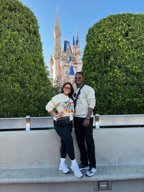 Couple in front of Disney castle in neutrals Disney Couple Outfits Winter, Disneyland Couple Outfits Winter, Disney In November Outfits, Disney Dad Outfits, Disney Mom Outfit Winter, Mom And Son Disney Outfits, Mom Disney Outfit Winter, Matching Disney Outfits Couples, Disney Outfits Couples