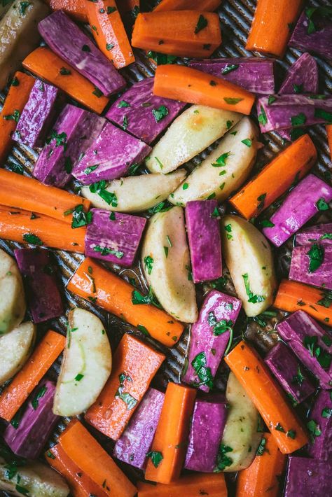 This is definitely not your average Thanksgiving side dish, but it's always good to switch things up a bit. Roasted carrots meets warm apples, sweet potatoes and fall spices. #roastedcarrotswithtahinidrizzle #thanksgivingrecipes #veganholidayrecipes #vegansidedish #glutenfreesidedish | crowdedkitchen.com Purple Carrot Meals, Sweet Potato Oven, Bright Line Eating Recipes, Sweet Potato Sides, Crowded Kitchen, Purple Sweet Potato, Vegan Holiday Recipes, Holiday Appetizers Recipes, Thanksgiving Side Dish