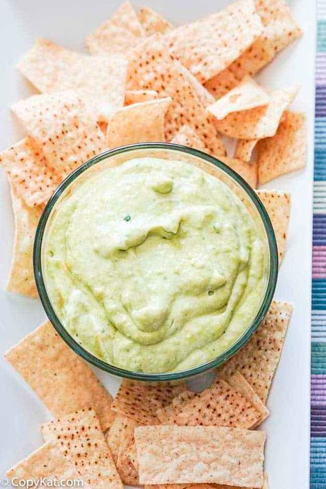 Ninfa's Mexican Green Sauce is a great dip to serve with tortilla chips for a tasty appetizer. Get the easy copycat recipe with tomatillo, avocado, green tomato, jalapeno, garlic, and sour cream. It's simple to make in a blender. This green sauce can be used for tacos, enchiladas, burritos, salads, and bowls. Perfect for Cinco de Mayo and game day football food. #mexicanfood #mexicanrecipes #greensauce #sauce #diprecipes #cincodemayo #appetizerrecipes #copycat #copycatrecipes #gamedayfood Mexican Green Sauce, Enchiladas Burritos, Creamy Avocado Salsa, Green Tomato Salsa, Green Sauce Recipe, Creamy Salsa, Sauces Recipes, Tomatillo Sauce, Creamy Avocado Sauce