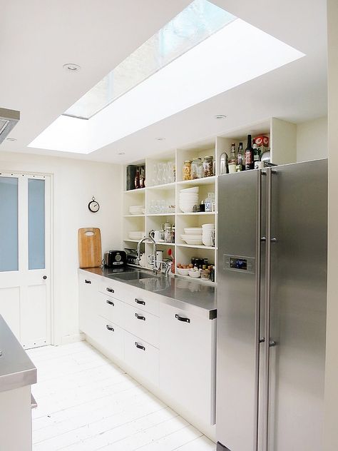 stainless countertops  Narrow kitchen looks a lot more spacious thanks to the skylight - Decoist Windowless Kitchen, Kitchen Skylight, Vaulted Ceiling Decor, Modern Skylights, Attic Kitchen, Vaulted Ceiling Kitchen, Full Kitchen Remodel, Skylight Design, Skylight Kitchen