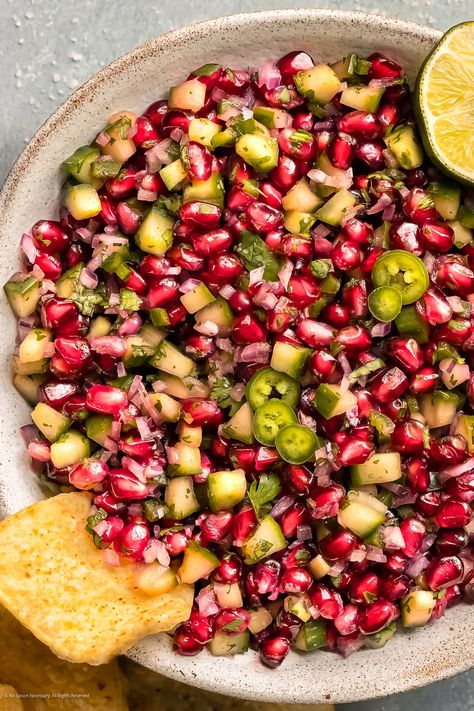 Overhead photo of pomegranate and cucumber salad in a bowl with a tortilla chip scooped into the salad. Pomegranate Salsa, Dip For Tortilla Chips, White Bean Hummus, Vinegar Chicken, Tortilla Chip, Cucumber Salsa, Pomegranate Recipes, Festive Appetizers, Pomegranate Salad