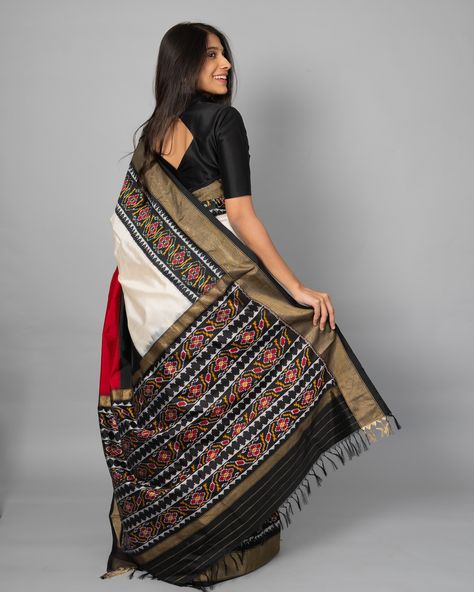 Ikat This color-blocked Ikat Silk Saree features red, black, and white shades, paired with a border featuring geometric floral motifs. [Summer Collection, Ikat silk saree, Tulsi Silks, Tulsi, Tulsi Weaves, Ikat Pattu, Pure Silk Sarees, Handwoven silk saree, Trending silk saree, Ikat sarees, Handwoven Ikat] Saree Trending, Tulsi Silks, White Shades, Silk Ikat, Indian Style, Pure Silk Sarees, Floral Motifs, Floral Motif, Pure Silk