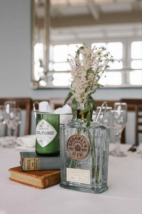 Liquor Bottle Vases Centerpieces, Centerpiece With Bottles, Simple Wedding Centerpieces Wine Bottles, Man Party Centerpieces, Flowers In Whiskey Bottles, Rum Bottle Centrepiece, Alcohol Wedding Centerpieces, Decanter Wedding Centerpiece, Liquor Bottle Vase