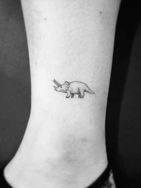 25 Minimalist Tattoos that Say More With Less (2022) - The Trend Spotter Triceratops Tattoo, Minimalist Symbols, Minimalist Tattoo Meaning, Paris Tattoo, Typography Tattoo, French Tattoo, Dinosaur Tattoos, 4 Tattoo, Delicate Tattoo