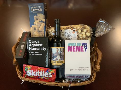 Great gift idea! Recreate this gift basket by visiting our website to find the store nearest you that carries #GameNightWine #merlot #themenightwines #cardsagainsthumanity #whatdoyoumeme #jenga #giftbasketideas #giftideas #housewarminggifts #giftideas #giftsforteachers #teachergiftideas #winebaskets #winegifts Jack And Jill Gift Basket Ideas, Prize Baskets For Adults, Prize Basket Ideas For Adults, Family Game Night Basket Ideas, Game Night Basket Ideas, Gift Basket Ideas Men, Tricky Tray Basket Ideas, Game Gift Basket, Game Night Gift Basket Ideas