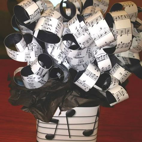 Centerpiece for music themed party. Printed music in paper, cut them in strips and curled them like ribbons. Attached to sticks and stuck them in sand in glass jars. Black tissue paper and printed music on paper wrapped around jar. Cheap and classy. Music Party Centerpieces, Band Banquet Ideas, Music Centerpieces, Music Theme Party, Music Decorations, Music Party Decorations, Music Theme Birthday, Music Themed Parties, Music Themed Wedding