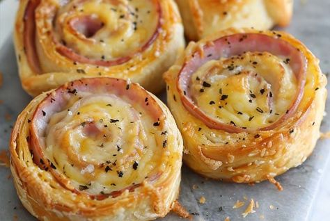 Discover the art of making Ham and Cheese Pinwheels with our simple guide. Perfect for parties, these snacks are sure to impress your guests! Phyllo Dough Ham And Cheese, Ham And Cheese Puff Pastry Pin Wheels, Ham And Cheese Puff Pastry Wheels, Ham And Cheese Swirled Pastries, Hot Ham And Cheese Pinwheels, Ham And Cheese Puff Pastry Pinwheels, Baking Appetizers, Pinwheels Baked, Making Ham