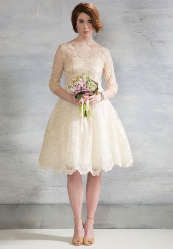 Short and sweet, this gorgeous knee-length dress is an excellent pick for brides who want to dance all night long without getting tangled in a long, elaborate train. Gilded Grace Dress in Champagne ($175, Modcloth.com) Modcloth Wedding Dress, Chi Chi London Dress, Retro Wedding Dresses, Short Lace Wedding Dress, Grace Dress, Vintage Style Wedding Dresses, Wedding Champagne, Wedding Dress Champagne, Champagne Dress