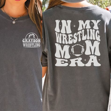 "Wrestling Mom Era Comfort Colors Shirt is the perfect gift for any wrestling mama this Christmas! Makes a great Mother's Day or Birthday Gift as well!  In the personalization box, enter the name you would like on your shirt. (Ex: Grayson) This shirt runs true to size.  If you want an oversized look, please order one size up.  If you want the oversized dress look, please size up two sizes. This is made with a 1717 Comfort Colors, garment-dyed t-shirt. Made with 100% ring-spun cotton, soft-washed Wrestling Mom Shirts, Youth Wrestling, Wrestling Gift, Sports Mom Gifts, Wrestling Shirts, Wrestling Mom, Mother Shirts, Mom Era, Weird Shirts