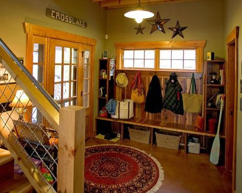 Arctic entry--typically the back entry.  A room with hooks, shelves and cubbyholes to hold boots and coats and whatnot that frequents in snowy weather.  Solid floors--tile or concrete--are a must to help minimize tracking snow in over wood or carpet.  Love the colors and natural wood trim. Cabin Entryway, Rustic Cabin Design, Rustic Entry, Rustic Entryway, Entry Design, Mud Room Storage, Rustic Cabin Decor, Cabin Style, Cabin Design