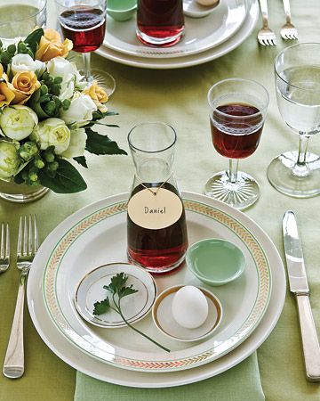 PASSOVER SEDER ~ In addition to displaying the main seder plate, incorporate some symbolic foods into individual place settings, add carafes of wine that can double as place card holders. With everything in reach, guests will have what they need during the reading of the Haggadah, keeping the passing of the seder plate -- and the risk of spills at the table -- to a minimum. Martha Stewart Entertaining, Passover Table Setting, Passover Seder Table, Passover Dinner, Seder Meal, Martha Stewart Holiday, Passover Table, Passover Seder Plate, Seder Table