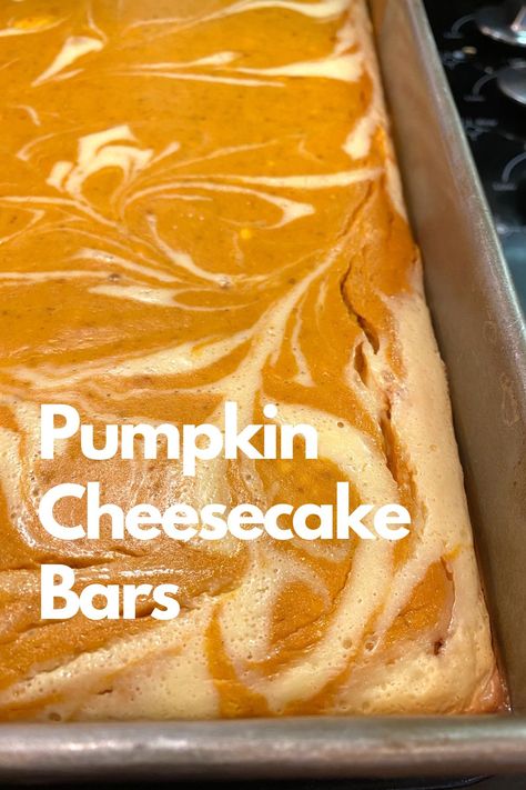 A baked pan of pumpkin cheesecake bars. Pumpkin Pie With Cheesecake Swirl, Creamy Pumpkin Pie Bars, Pumpkin Pie Slab Bars, Pumpkin Cheesecake Swirl Bars, Pumpkin Bars 9x13 Pan, Pumpkin Swirl Cheesecake Bars, Small Batch Pumpkin Bars, Pumpkin Cheesecake Bars Easy, Pumpkin Bars With Cream Cheese Frosting