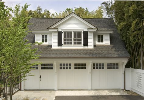 This carriage house with lots of charm and detail has three car bays, a pool changing area and includes a guest suite on the second floor. Above Garage Apartment, Garage Plans Detached, Plan Garage, Carriage House Garage, Garage Guest House, Apartment Exterior, Garage Addition, Garage Apartment Plans, Carriage Doors